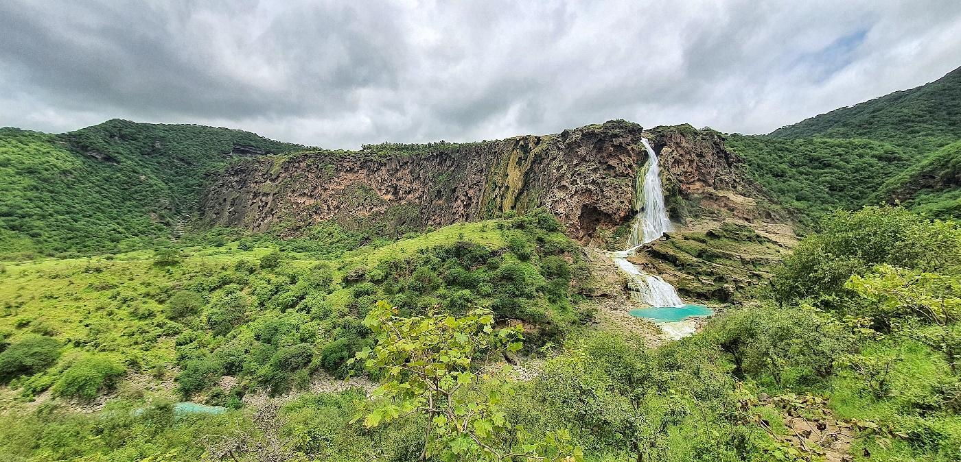 Green Dhofar mountains and waterfall near Salalah, southern Oman